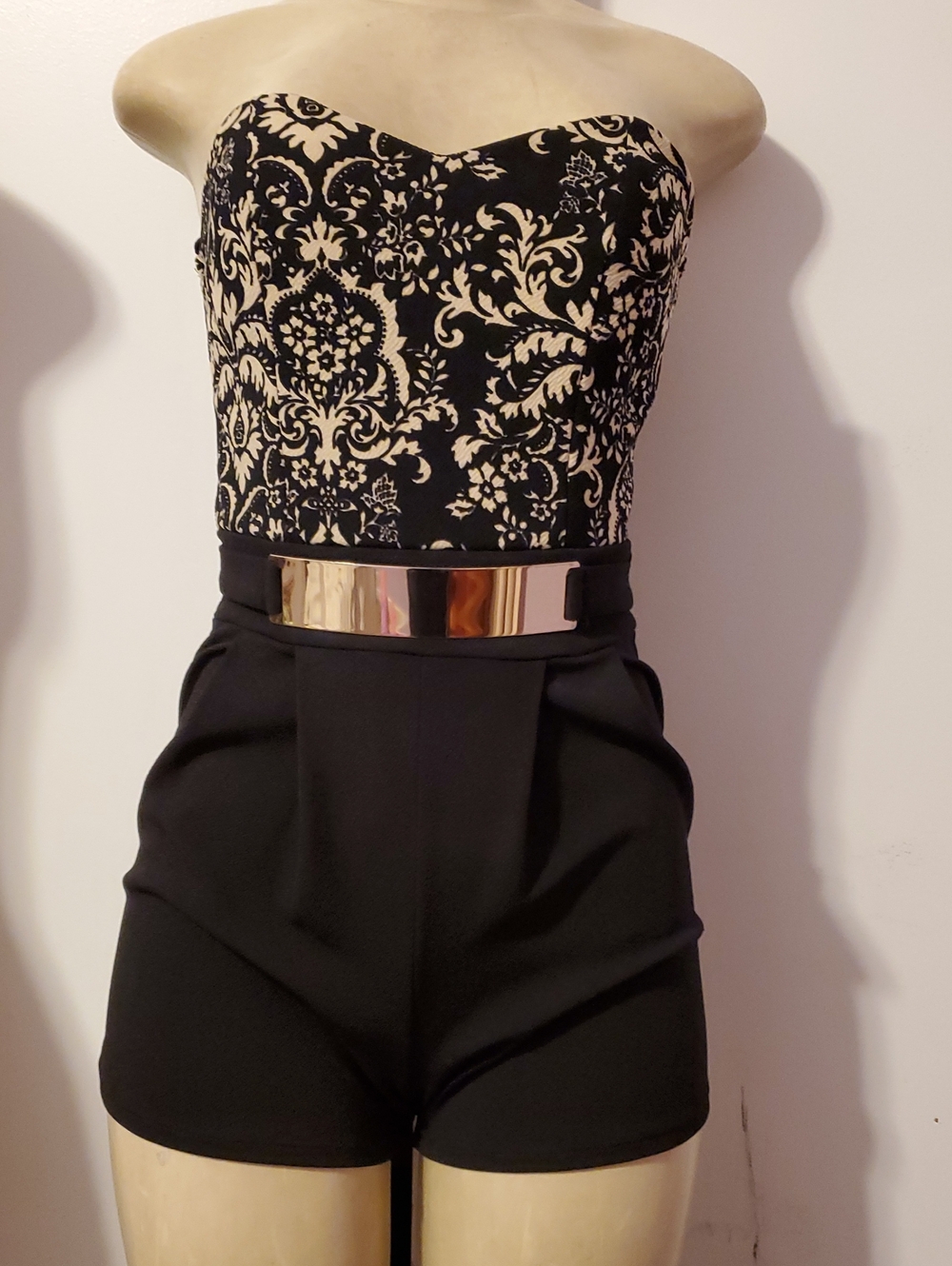 Fashion Magazine Strapless Black and Cream Patterned Romper with Gold Belt
